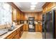 This kitchen features all wood cabinets, tile backsplash, and modern appliances at 151 Donnibrook, Fuquay Varina, NC 27526