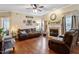 Inviting living room featuring a cozy seating arrangement, a fireplace, and natural light from the windows at 151 Donnibrook, Fuquay Varina, NC 27526