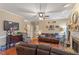 Comfortable living room with a fireplace, hardwood floors, and a large TV for entertainment, with neutral paint at 151 Donnibrook, Fuquay Varina, NC 27526