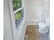 Bathroom with white tile, natural light and standard fixtures at 1522 Goodwin Rd, Durham, NC 27712