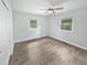 Bedroom with neutral paint, ceiling fan and two large windows at 1522 Goodwin Rd, Durham, NC 27712