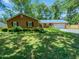 Charming single-story brick home with a well-manicured lawn and mature trees in a quiet neighborhood at 1522 Goodwin Rd, Durham, NC 27712