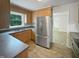 Kitchen featuring stainless steel appliances, wooden cabinetry, and durable countertops at 1522 Goodwin Rd, Durham, NC 27712