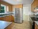 Kitchen featuring stainless steel appliances, wooden cabinetry, and durable countertops at 1522 Goodwin Rd, Durham, NC 27712