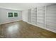 Bright living room boasts hardwood floors and built-in shelving for ample storage at 1522 Goodwin Rd, Durham, NC 27712