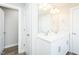 Bathroom boasts a double vanity, framed mirror, modern light fixture, tile floor, and a doorway at 160 Tupelo Dr, Spring Hope, NC 27882