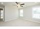 Bright bedroom with neutral carpet, ceiling fan, and two windows providing natural light at 160 Tupelo Dr, Spring Hope, NC 27882