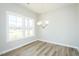 Bright dining room featuring hardwood floors, a modern chandelier, and large windows at 160 Tupelo Dr, Spring Hope, NC 27882