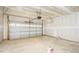 Unfinished garage with white garage door, ample overhead storage racks and concrete floor at 160 Tupelo Dr, Spring Hope, NC 27882
