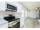 Bright kitchen featuring stainless steel appliances, granite countertops, and modern lighting at 160 Tupelo Dr, Spring Hope, NC 27882