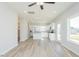Open kitchen with stainless steel appliances, white cabinets, and wood-look floors at 160 Tupelo Dr, Spring Hope, NC 27882