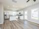 Open kitchen boasts stainless appliances, granite counters, and wood-look floors at 160 Tupelo Dr, Spring Hope, NC 27882
