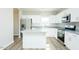 Bright kitchen featuring stainless steel appliances, white cabinets, and hardwood floors at 160 Tupelo Dr, Spring Hope, NC 27882