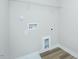 Bright laundry room with wood-look floors, washer/dryer hookups, and wire shelf at 160 Tupelo Dr, Spring Hope, NC 27882