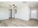Bright living room with wood-look floors, neutral walls, ceiling fan, and staircase at 160 Tupelo Dr, Spring Hope, NC 27882