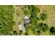 Expansive aerial view of wooded property with buildings, outbuildings and other structures at 1661 Reno Sharps Store Rd, Bear Creek, NC 27207