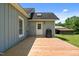 Back view of the home featuring a wooden deck and gray siding, with a lush green yard and blue sky at 1661 Reno Sharps Store Rd, Bear Creek, NC 27207