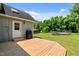 View of the wooden deck and home exterior with a grill and a hot tub on the well-manicured lawn at 1661 Reno Sharps Store Rd, Bear Creek, NC 27207