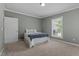 A serene bedroom featuring a bed, carpet and a window, offering a peaceful retreat at 1661 Reno Sharps Store Rd, Bear Creek, NC 27207
