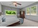 Inviting bedroom featuring a bed, dresser, soft carpet, and natural light from multiple windows at 1661 Reno Sharps Store Rd, Bear Creek, NC 27207