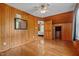 Spacious bedroom with beautiful wood paneling, hardwood floors and walk-in closet at 1661 Reno Sharps Store Rd, Bear Creek, NC 27207
