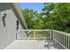 Outdoor deck with white railings, perfect for enjoying the surrounding nature at 1661 Reno Sharps Store Rd, Bear Creek, NC 27207