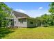 Exterior view of the home with gray siding, showing the porch and side, surrounded by a lush green lawn at 1661 Reno Sharps Store Rd, Bear Creek, NC 27207