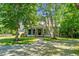 Charming home featuring a welcoming front porch, classic design and beautiful front yard at 1661 Reno Sharps Store Rd, Bear Creek, NC 27207