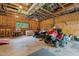 Garage featuring exposed wood framing, large windows, and various tools and equipment at 1661 Reno Sharps Store Rd, Bear Creek, NC 27207