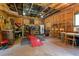 Garage featuring exposed wood framing, large windows, and work benches with lots of tools and equipment at 1661 Reno Sharps Store Rd, Bear Creek, NC 27207