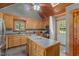 Well-lit kitchen with a center island, wooden cabinets, and a vaulted ceiling with a skylight at 1661 Reno Sharps Store Rd, Bear Creek, NC 27207