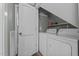 Efficient laundry area with washer, dryer, shelving, and convenient storage space at 1661 Reno Sharps Store Rd, Bear Creek, NC 27207