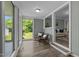 Bright sunroom with large windows, comfortable seating, and serene views of the outdoor landscape at 1661 Reno Sharps Store Rd, Bear Creek, NC 27207