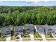 Aerial view of three homes and backyards, showcasing manicured lawns, driveways, and landscaping at 168 Amber Acorn Ave, Raleigh, NC 27603