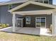 View of covered patio and the house's exterior with sliding glass doors and green lawn at 168 Amber Acorn Ave, Raleigh, NC 27603