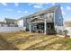 The fenced backyard has a covered patio with seating and room for entertaining at 168 Amber Acorn Ave, Raleigh, NC 27603