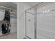 Modern bathroom with walk-in closet and tiled shower with glass door at 168 Amber Acorn Ave, Raleigh, NC 27603
