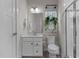 Modern bathroom with a vanity, toilet, and shower with glass enclosure, accented with hanging plants at 168 Amber Acorn Ave, Raleigh, NC 27603