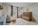 Cozy Bedroom with wood crib, rug, and decor at 168 Amber Acorn Ave, Raleigh, NC 27603