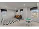 Spacious bonus room with neutral carpet, gray sofa, and two windows at 168 Amber Acorn Ave, Raleigh, NC 27603