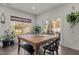 Bright dining area featuring a wooden table, black chairs, and natural light from large windows at 168 Amber Acorn Ave, Raleigh, NC 27603