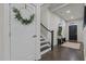 Welcoming entryway with dark hardwood floors, white trim, stairs, and a decorated door at 168 Amber Acorn Ave, Raleigh, NC 27603