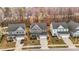 An aerial view of three beautiful, well-maintained two story homes, set in a row on a tree-lined street at 168 Amber Acorn Ave, Raleigh, NC 27603