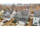 Aerial shot of the home's exterior, showcasing its well-kept lawn, two-car garage, and neighborhood at 168 Amber Acorn Ave, Raleigh, NC 27603