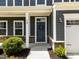 Charming front porch featuring decorative wreath, stone accents and well-maintained landscaping at 168 Amber Acorn Ave, Raleigh, NC 27603