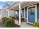 Inviting front porch with rocking chairs, planters, and a blue front door at 168 Amber Acorn Ave, Raleigh, NC 27603