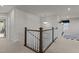 Second floor hallway with white and dark wood banister overlooking lower level at 168 Amber Acorn Ave, Raleigh, NC 27603