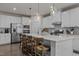 Spacious kitchen featuring white cabinets, stainless steel appliances, and large center island at 168 Amber Acorn Ave, Raleigh, NC 27603