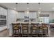 Modern eat-in kitchen with white cabinets, stainless steel appliances, and a center island with seating at 168 Amber Acorn Ave, Raleigh, NC 27603