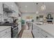 Stylish kitchen with stainless steel appliances, center island with sink, and view of the dining area at 168 Amber Acorn Ave, Raleigh, NC 27603